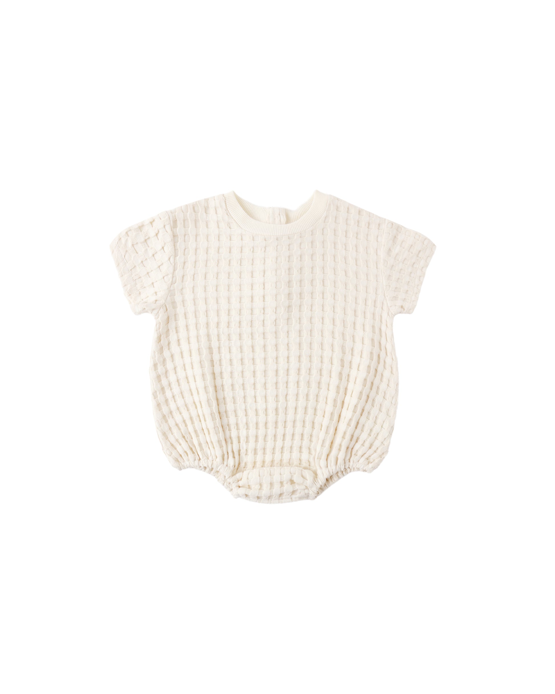 Natural relaxed bubble romper for babies by Quincy Mae, soft fabric with a comfortable, loose fit and gentle design.