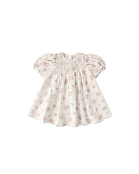 Ivory Garden Rose Carina Dress by Quincy Mae with floral pattern and ruffled sleeves displayed on a hanger.