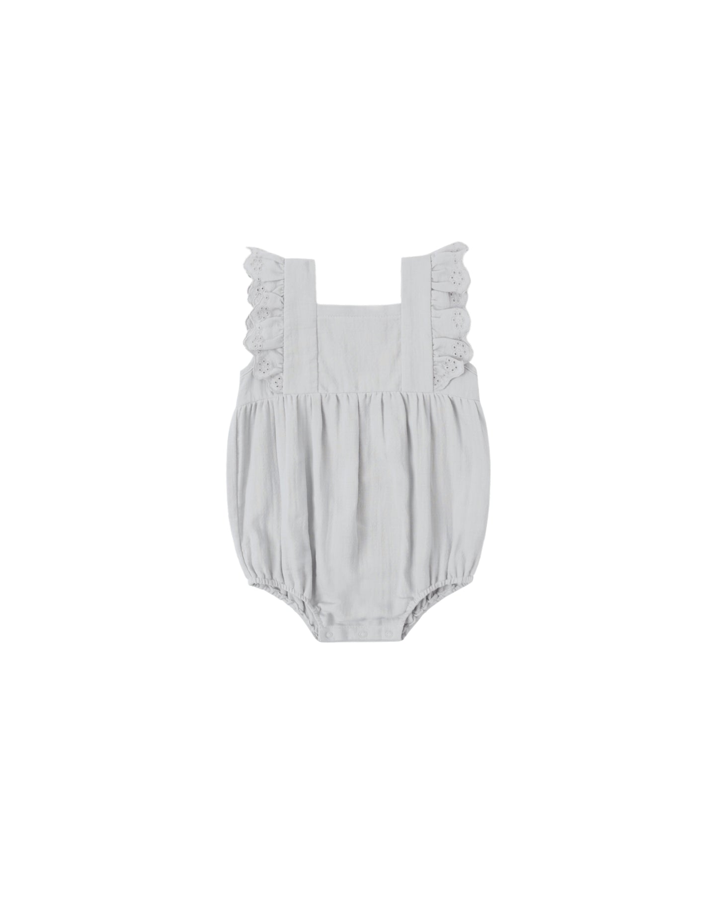 Sky Naomi romper by Quincy Mae, soft blue cotton one-piece with short sleeves and button closure, displayed on a hanger.