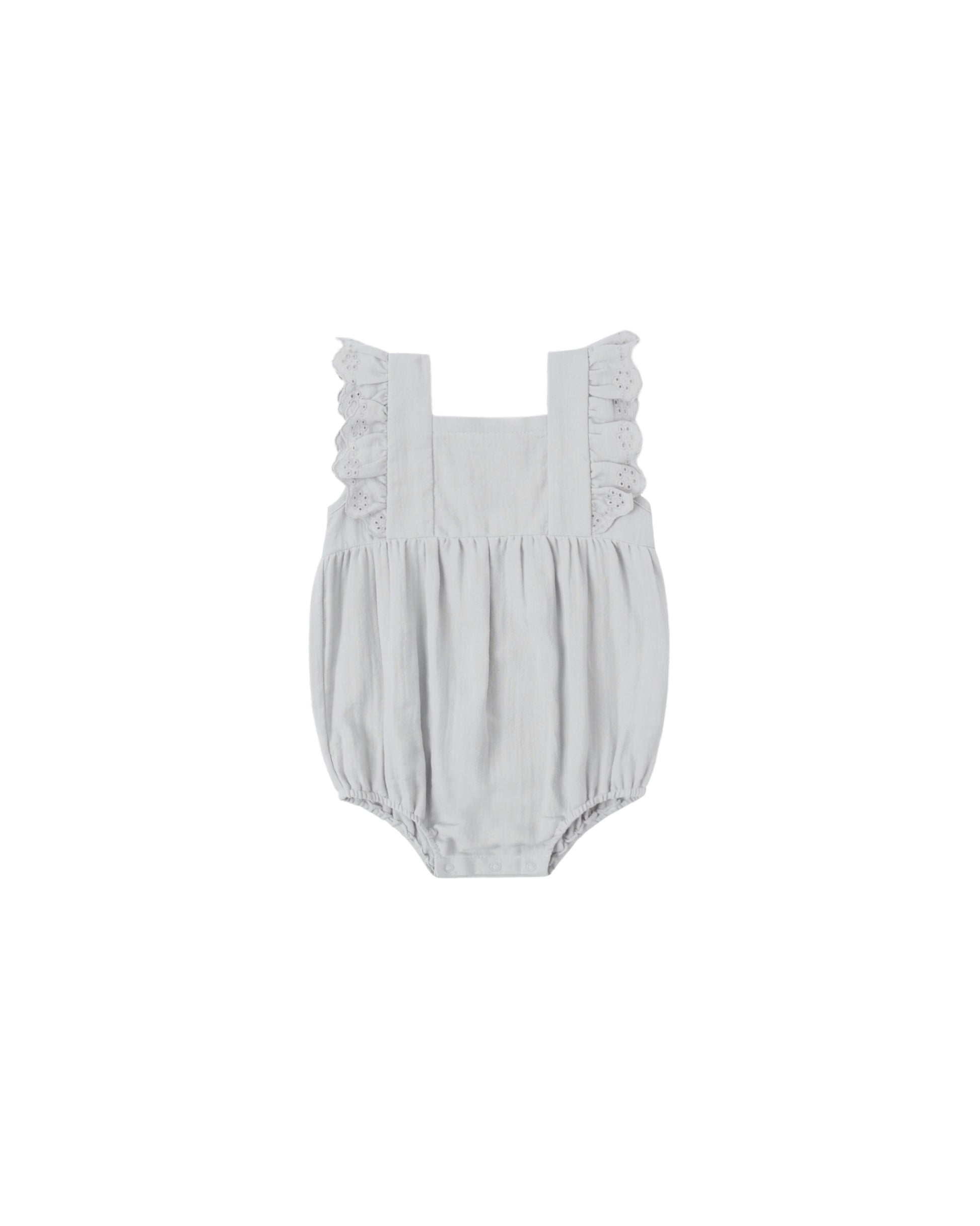Sky Naomi romper by Quincy Mae, soft blue cotton one-piece with short sleeves and button closure, displayed on a hanger.