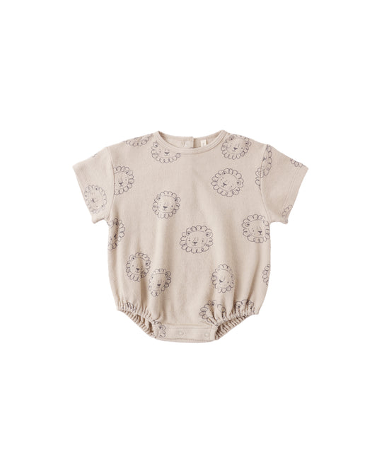 Baby wearing Quincy Mae Lion relaxed short sleeve bubble romper in a soft oat color, showing comfortable, cozy fabric and relaxed fit.