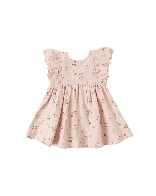 Quincy Mae Cherries Alina Dress in blush fabric, featuring a soft, flowy design with cherry print details.