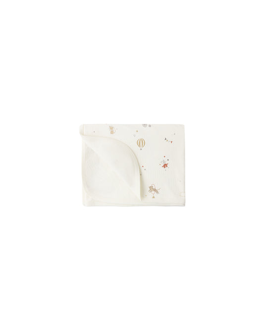 Quincy Mae Carnival Swaddle in ivory, soft organic cotton with playful bee pattern, perfect for newborns and infants.