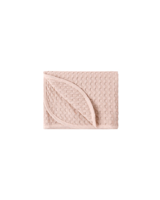 Soft blush waffle baby blanket by Quincy Mae, featuring textured fabric and cozy, lightweight design for infants.