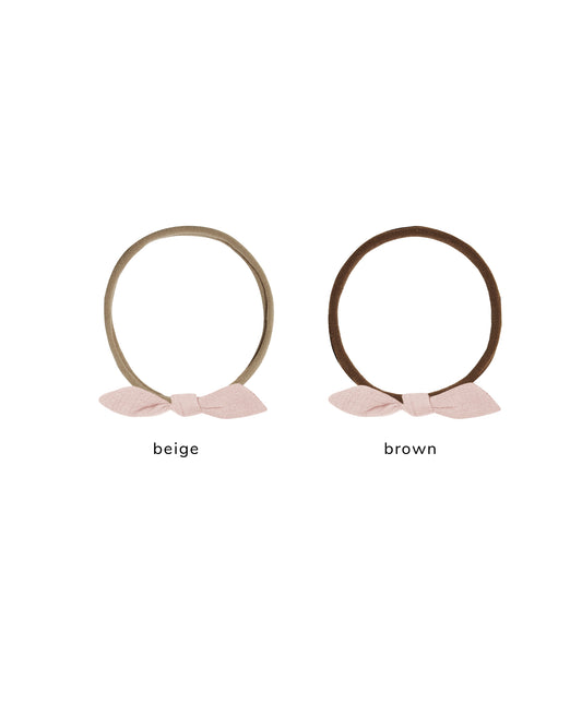 Soft blush pink Little Knot headband by Quincy Mae, featuring a gentle fabric knot design for a cute, comfortable accessory.