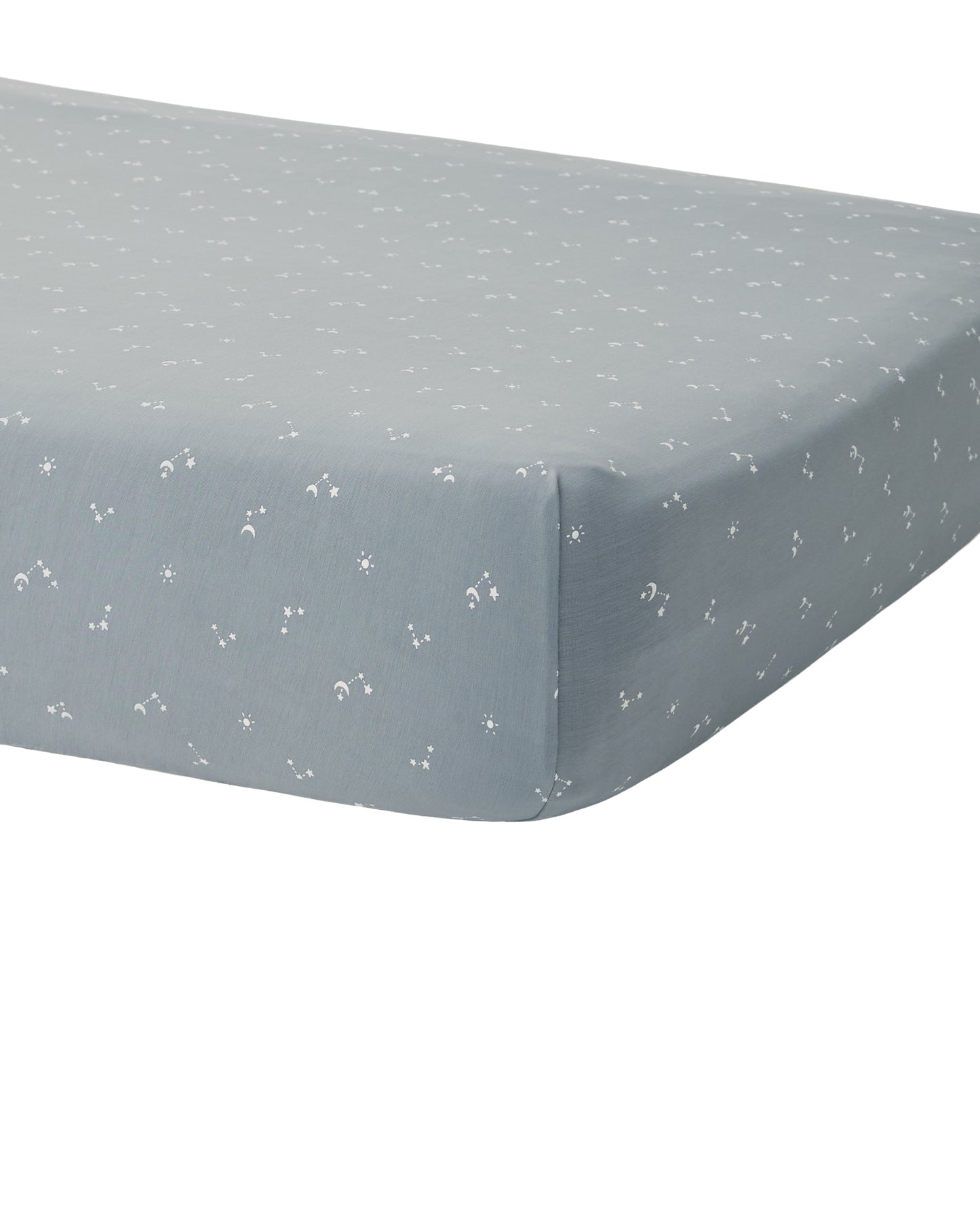 Soft bamboo crib sheet from Quincy Mae with ocean blue pattern, fitted on a baby crib mattress.