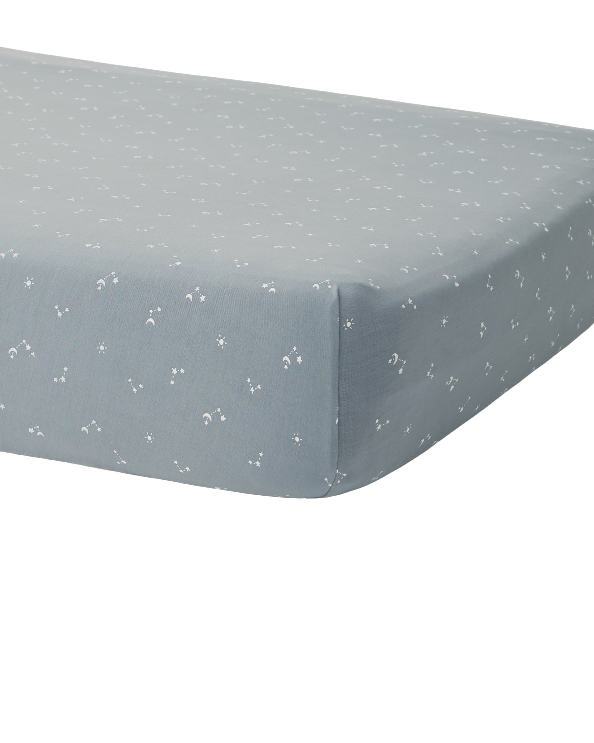 Soft bamboo crib sheet from Quincy Mae with ocean blue pattern, fitted on a baby crib mattress.