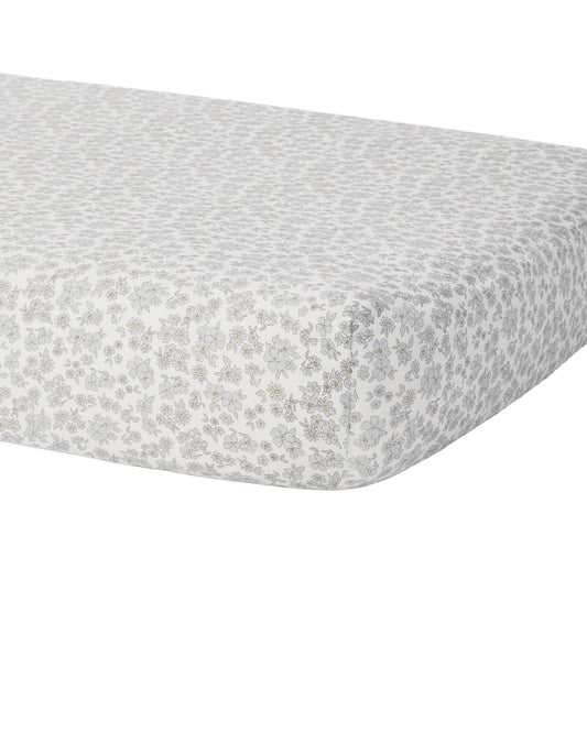 Blue floral bamboo crib sheet by Quincy Mae, showcasing soft fabric with a delicate floral print on a crib mattress.