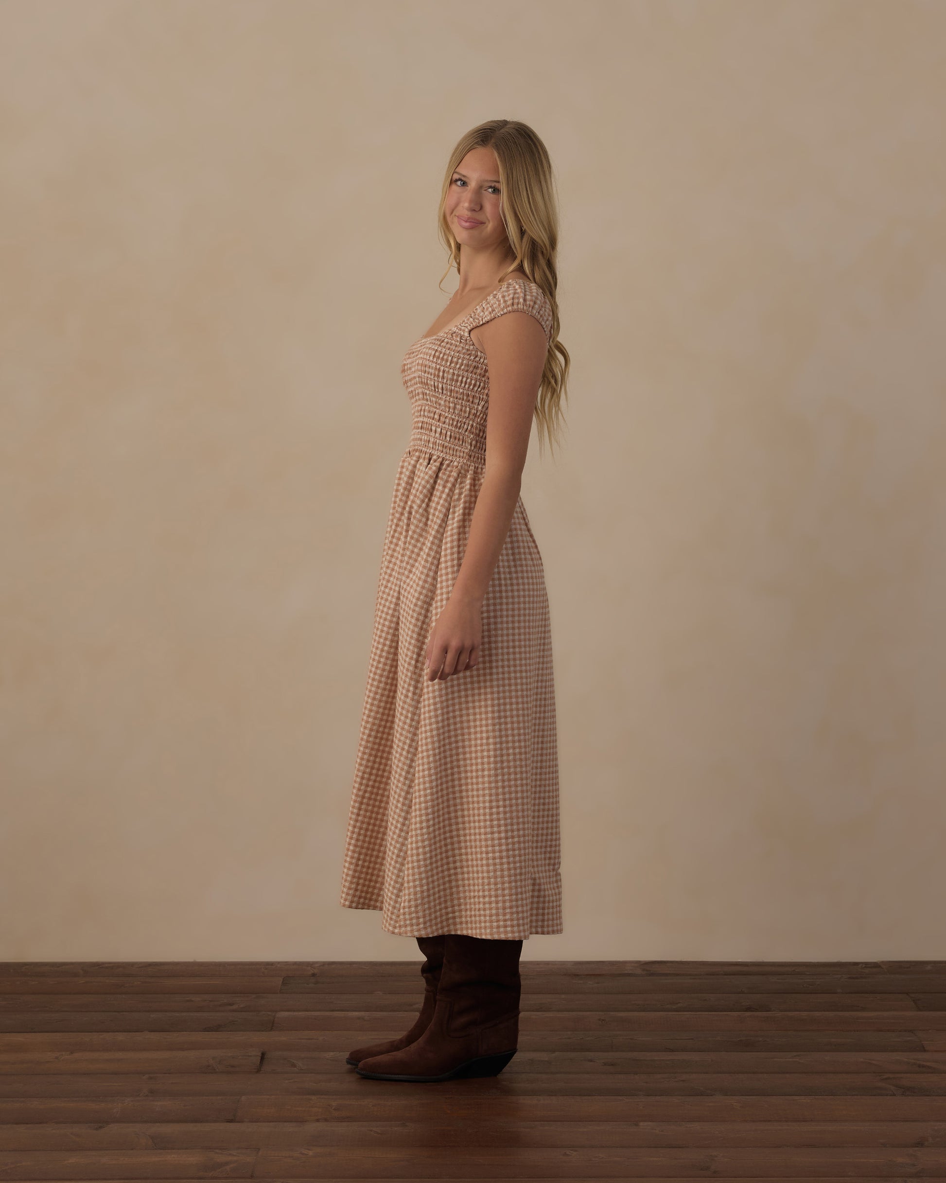 Teen girl wearing Rylee & Cru Teen Fawn Gingham Jess Dress with short sleeves and ruffled details, front view.
