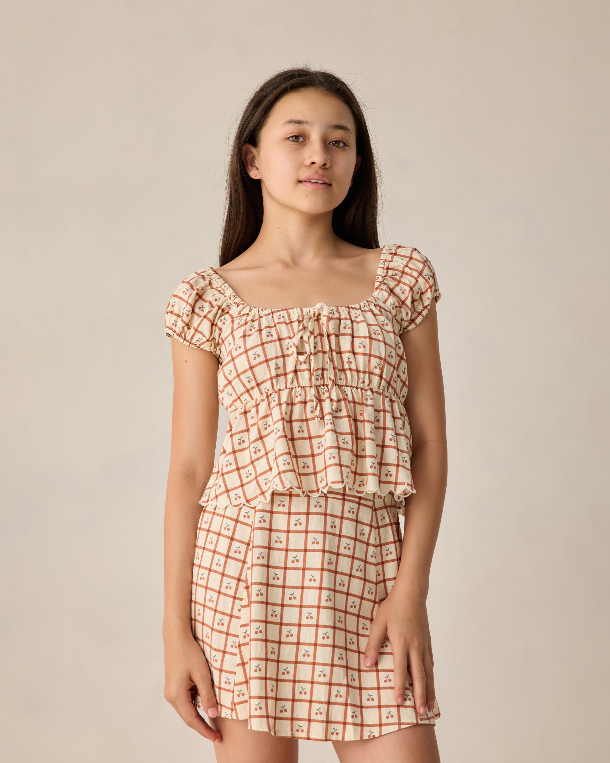 Teen Cherry Check Rylan Top by Rylee & Cru, featuring a stylish red and white checkered design, long sleeves, and a relaxed fit.