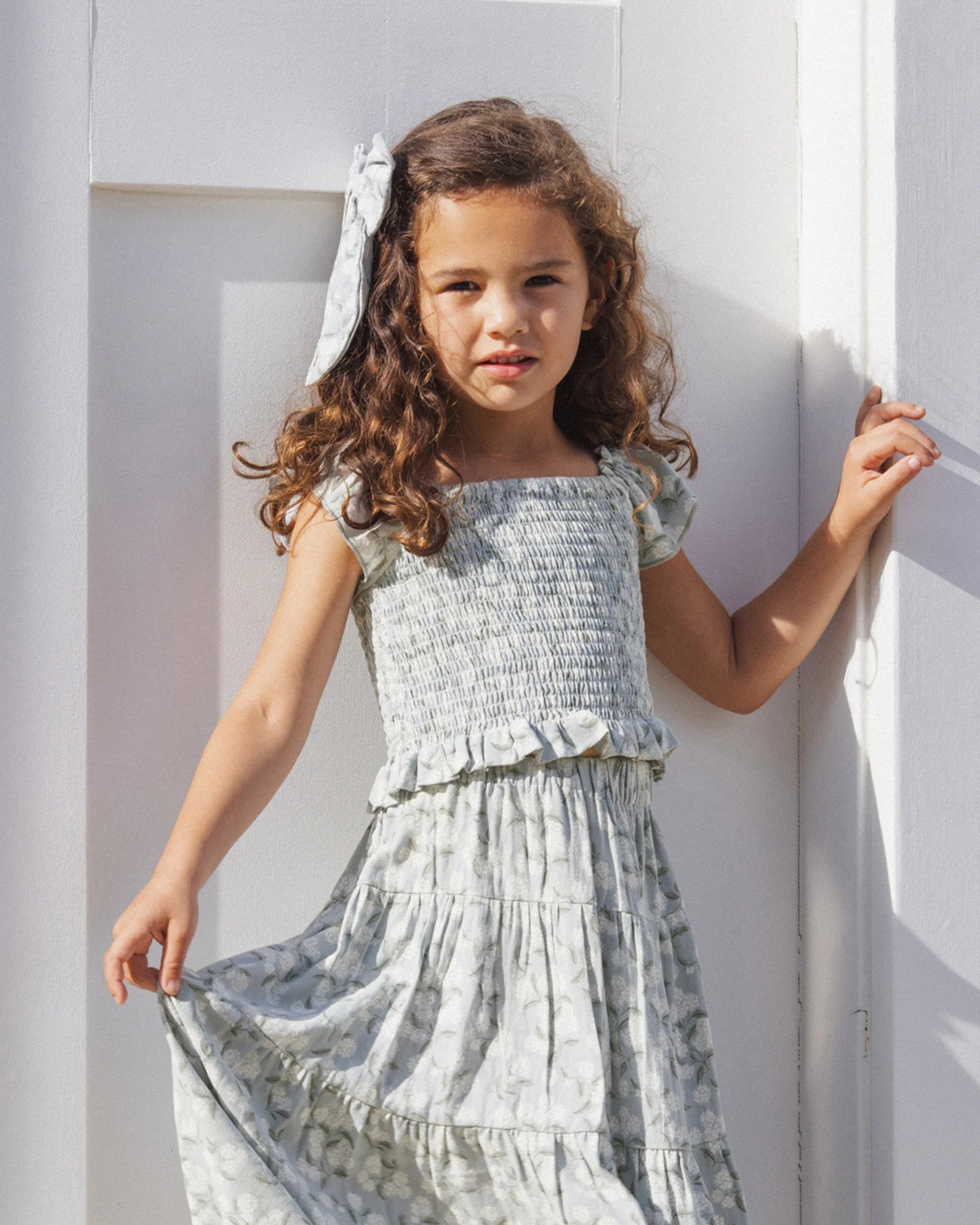 Rylee & Cru Hydrangea Zayla top in soft fabric, shown on a girl wearing the floral-patterned top in a casual lifestyle setting.