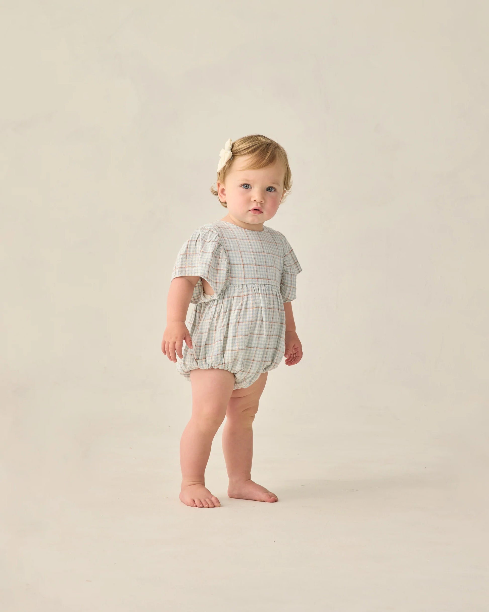 Light blue plaid Kalea romper by Rylee & Cru featuring short sleeves, a relaxed fit, and a cute, casual style.