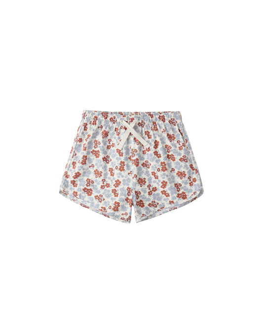 Rylee & Cru Americana floral swim trunk with blue and red flower print, lightweight fabric, and elastic waistband.