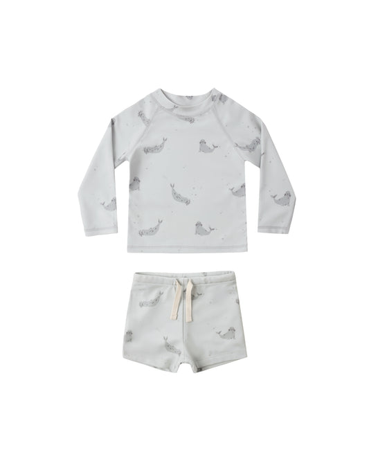 Blue Seals Boys Rashguard Set by Rylee & Cru featuring a long-sleeve rashguard and matching swim shorts for kids.