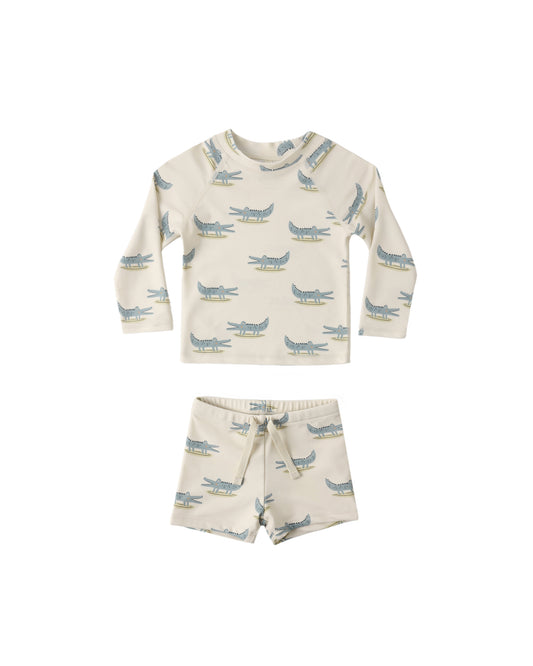 Alligators boys rashguard set by Rylee & Cru featuring a natural-colored long-sleeve swim shirt with alligator print.