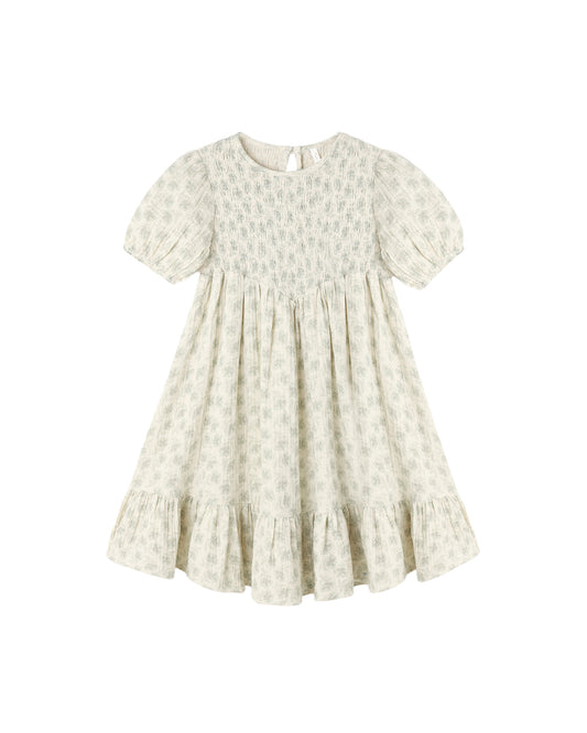 Green Iris Lydia Dress by Rylee & Cru, natural fabric with a flowing silhouette, shown on a hanger.