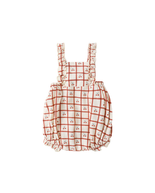 Cherry Check Chiara Romper by Rylee & Cru, natural fabric with a playful cherry check pattern, displayed on a hanger.