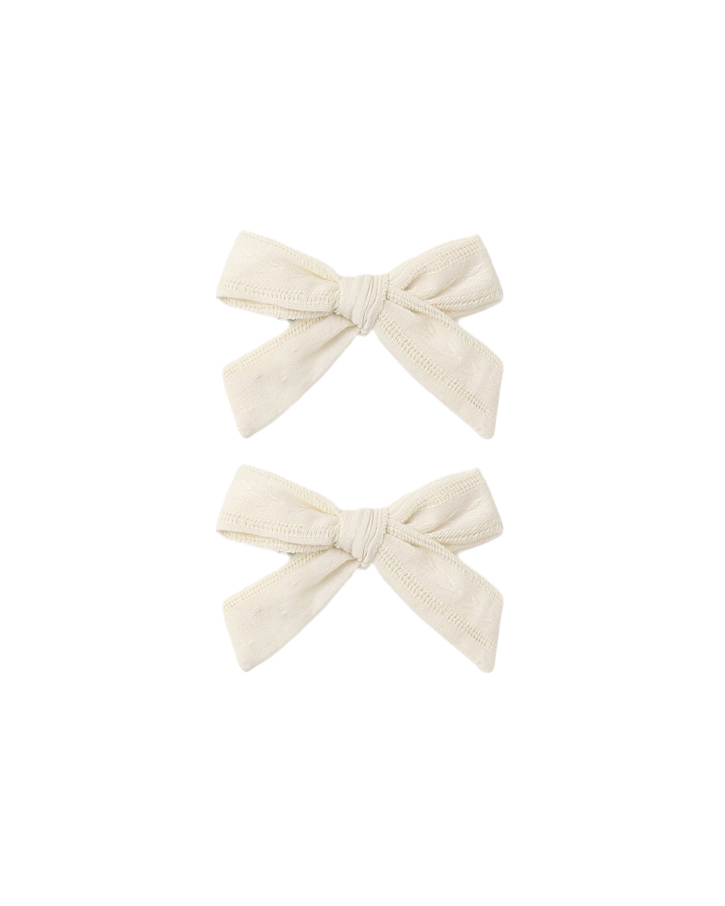 Set of two natural-colored fabric bows by Rylee & Cru, perfect for baby girl accessories or hair embellishments.