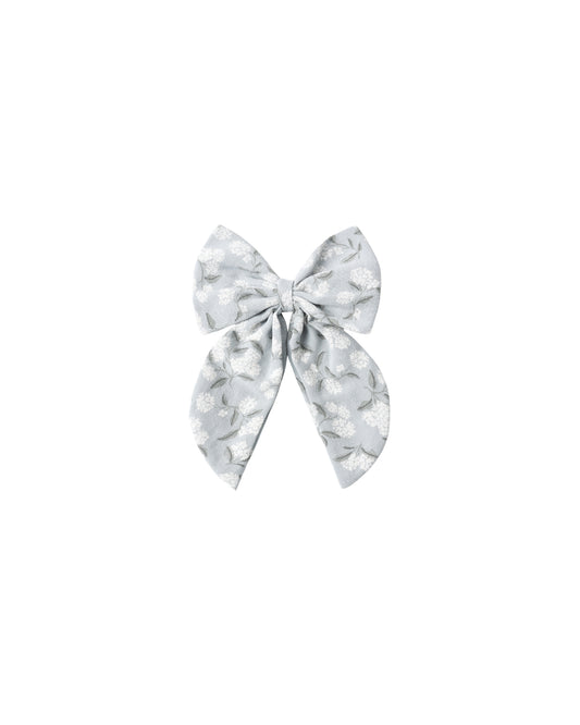 Light blue Hydrangea oversized bow by Rylee & Cru, featuring large, lush fabric flowers for decorative use or gift wrapping.