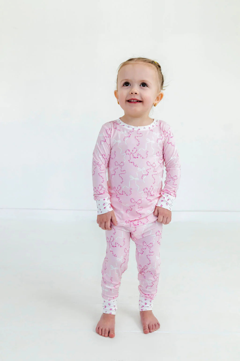 In My Jammers Cora Floral Bows two-piece set with matching top and shorts featuring colorful floral patterns.