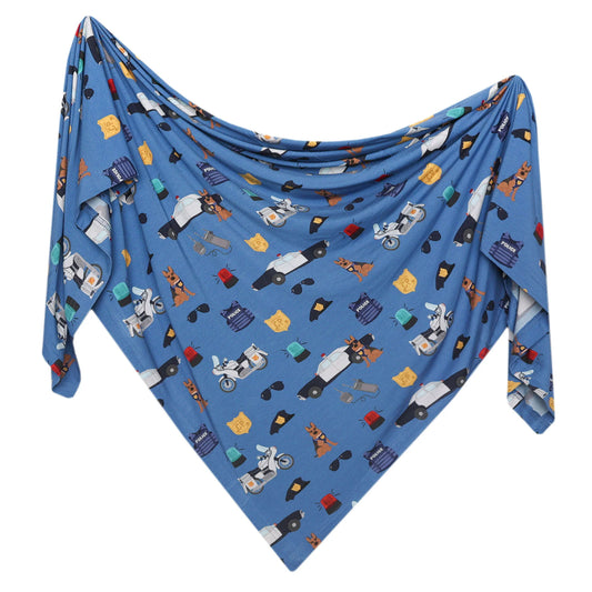 Copper Pearl Policemen Bamboo Swaddle featuring a playful policeman print, soft and breathable fabric for newborn comfort.