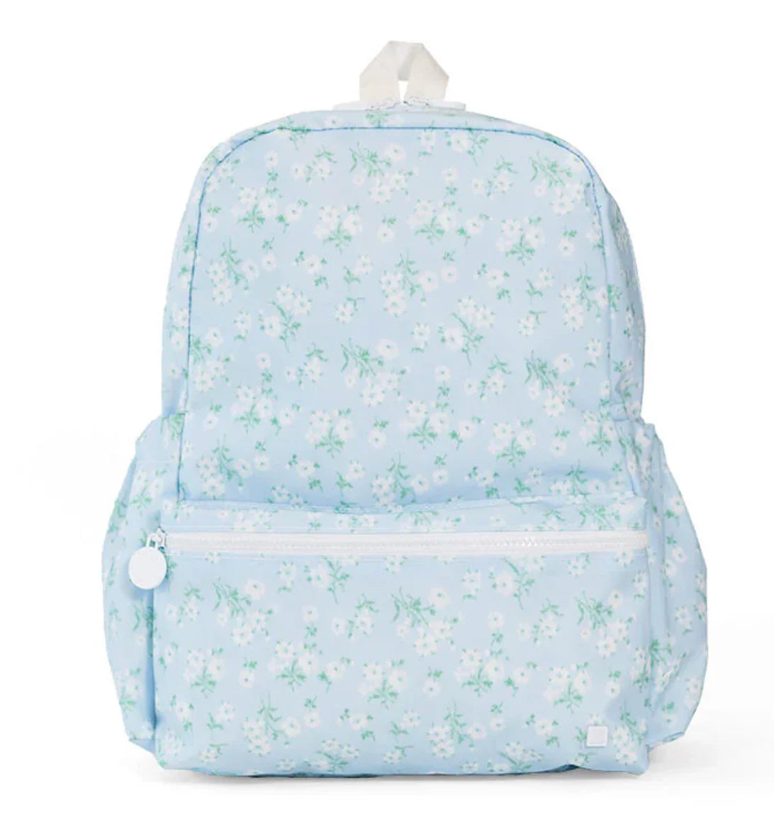 TRVL Designs backpack with a vibrant floral pattern, featuring adjustable straps and multiple compartments for everyday use.