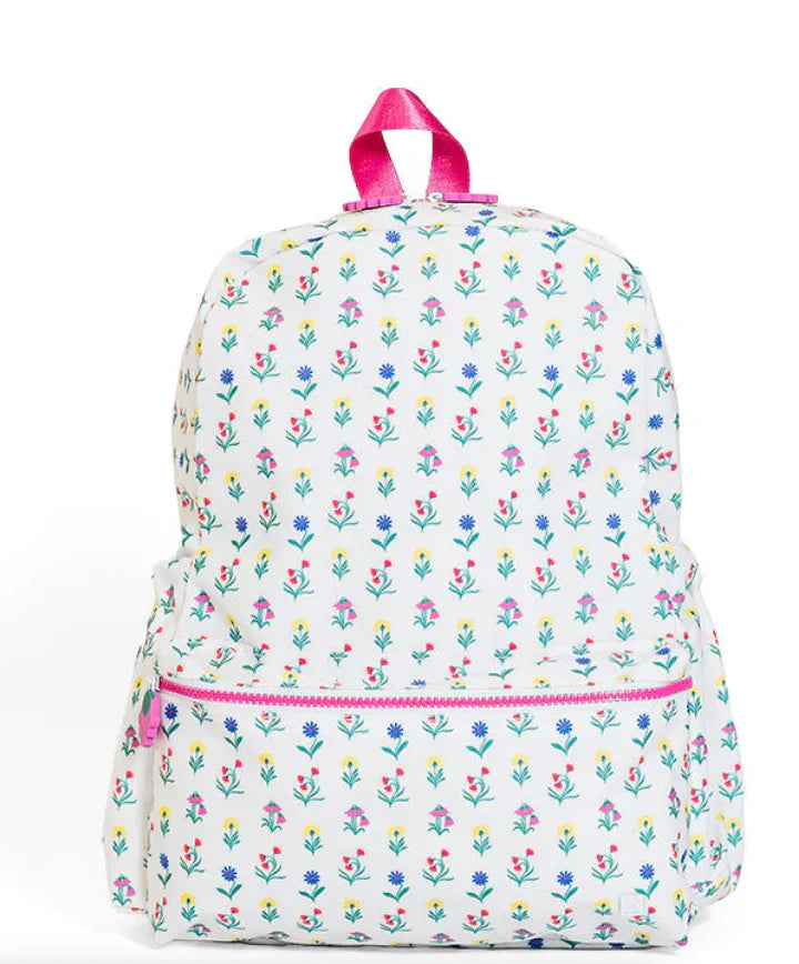 TRVL Design backpack with a vibrant wildflower pattern, featuring adjustable straps and multiple compartments.
