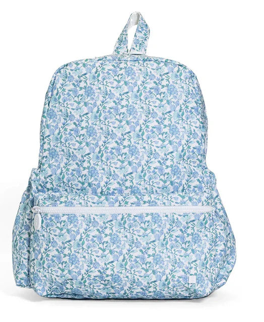 TRVL Designs backpack featuring a floral Hamptons pattern, with adjustable straps and multiple compartments for everyday use.