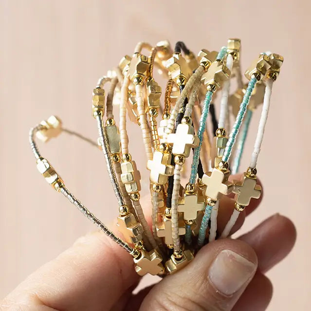 Lenny & Eva Faithful Bangles set featuring multiple gold-tone metal bangles with engraved and smooth finishes.