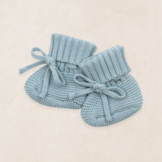 Lou Lou & Co Steele Knit Booties in blue, featuring soft knit material and a cozy design for infants.