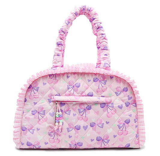 Quilted cherry bow print medium duffle bag by OMG Accessories with quilted design and bow pattern, view of front and handle details.