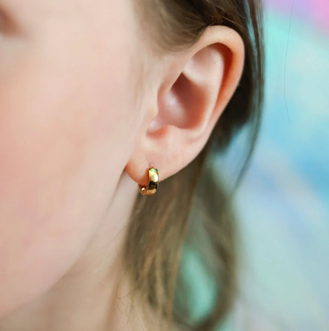 Gold 6mm chunky huggie earrings by Pierced Co, featuring bold, wide hoops perfect for a stylish, modern look.