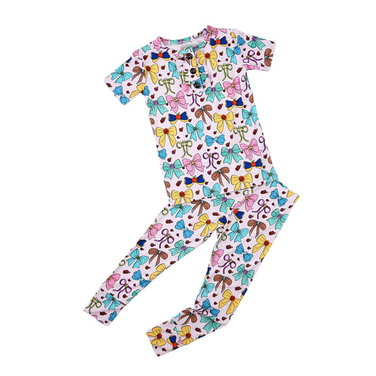 Gigi & Max Princess Bows Ruffle Two Piece Lounge Set with pink top and matching ruffled shorts for girls.