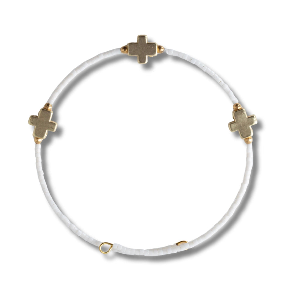 Lenny & Eva Faithful Bangles set featuring multiple gold-tone metal bangles with engraved detailing and a polished finish.