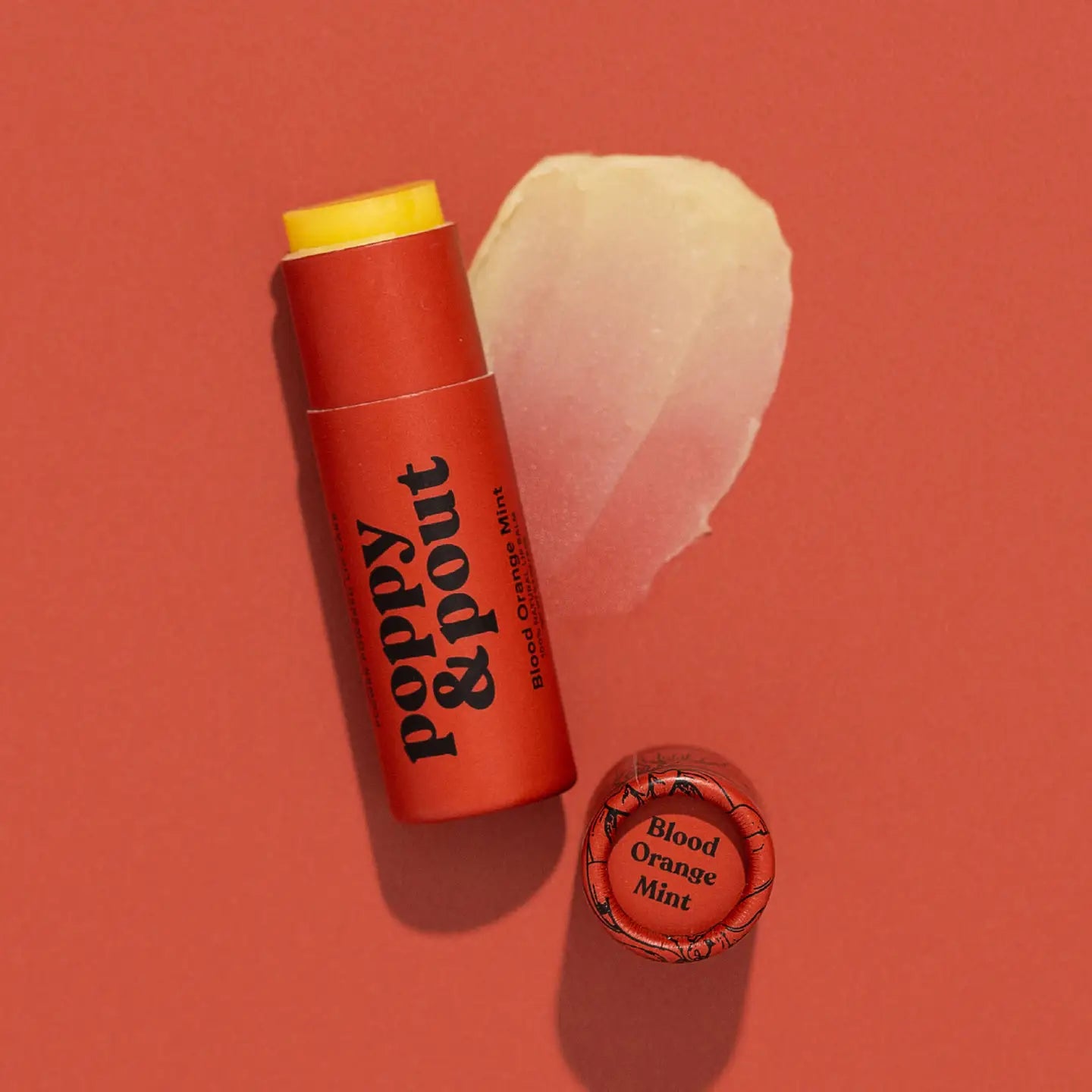 Sweet E's Children's Boutique Poppy & Pout lip balm in a colorful container with pink and purple packaging.