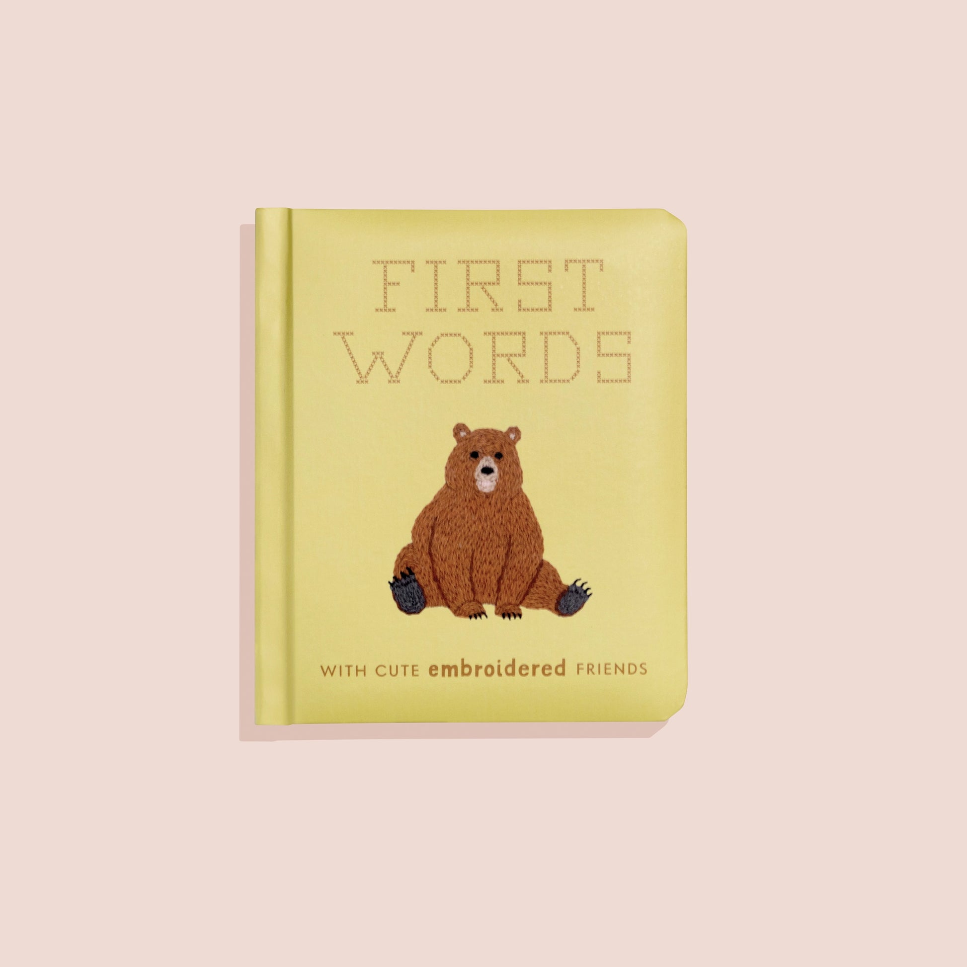 Colorful children's book titled First Words with cute embroidered animal friends by Sweet E's Children's Boutique, featuring playful illustrations.
