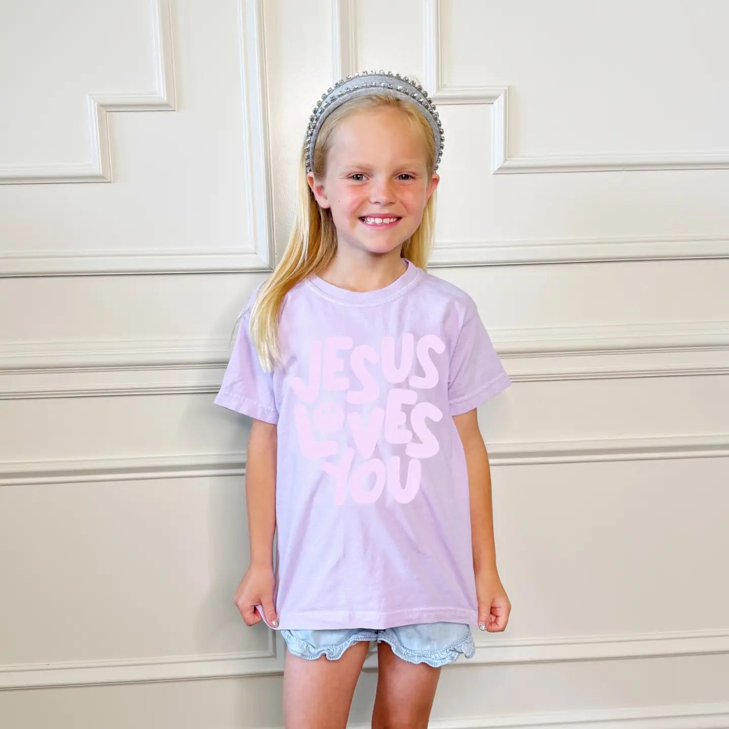 Purple Smiley Jesus Loves You Puff Youth T-shirt by Poppy & Pine featuring a cheerful smiley face and religious message.