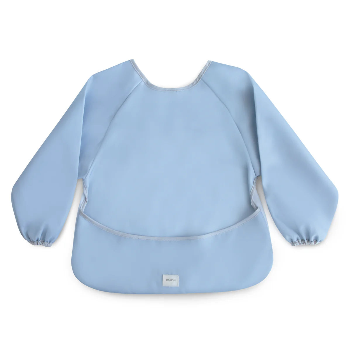 Mushie long sleeve bib in trade winds color, featuring soft fabric and adjustable neck, designed to protect baby’s clothing during meals.