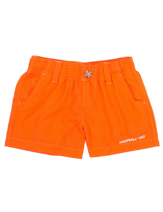 Boys Mallard Short in orange by Properly Tied, featuring a bright color and casual fit, shown on a young boy.