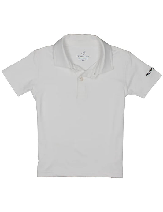 Boy wearing a white Academy polo shirt by Properly Tied, front view showing collar and button placket.