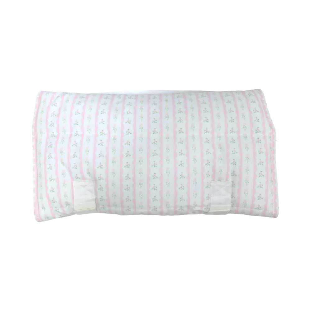 Pink floral ribbon on TRVL Design nap mat with colorful geometric patterns, perfect for preschool nap time.