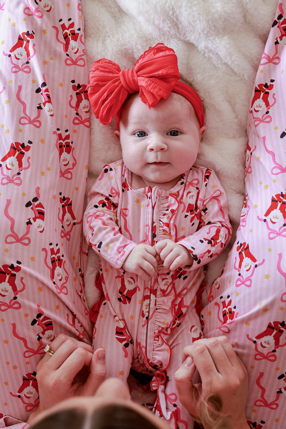 Caden Lane Jolly Ribbons Christmas Ruffle Zipper Footie for babies, featuring festive red and white ribbon pattern and cozy fabric.
