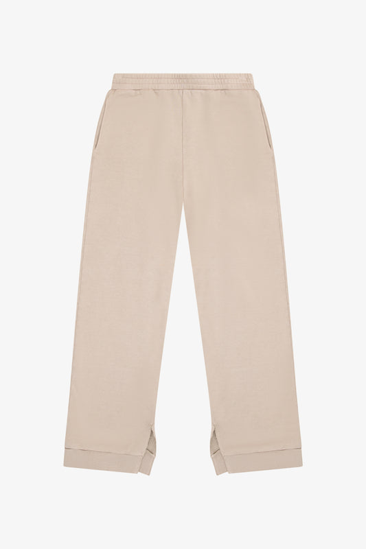 TENLY soy latte split hem pants displayed on a model, showcasing relaxed fit and stylish design with a split hem detail.