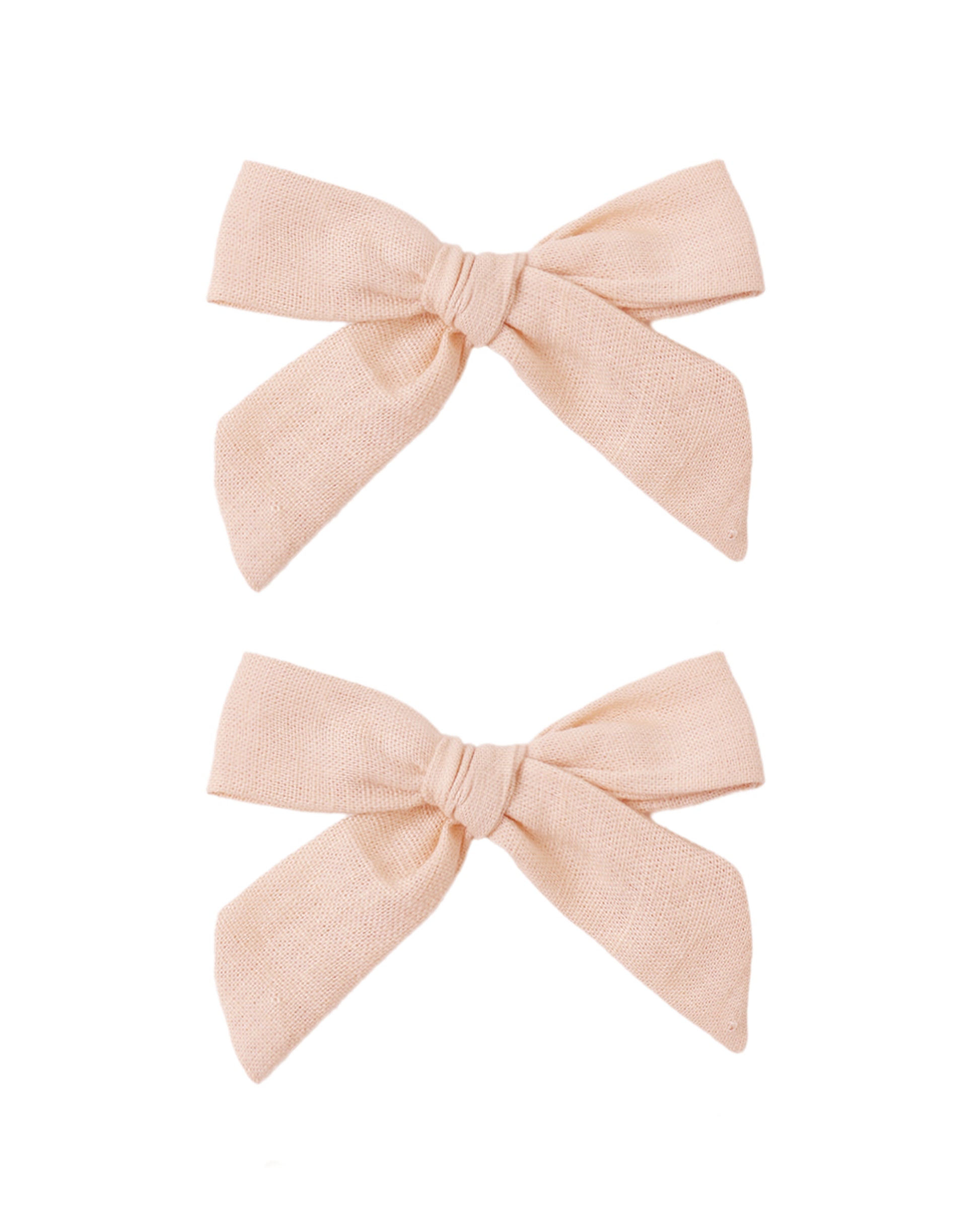 Set of two blush-colored fabric bows by Rylee & Cru, perfect for baby or toddler hair accessories.