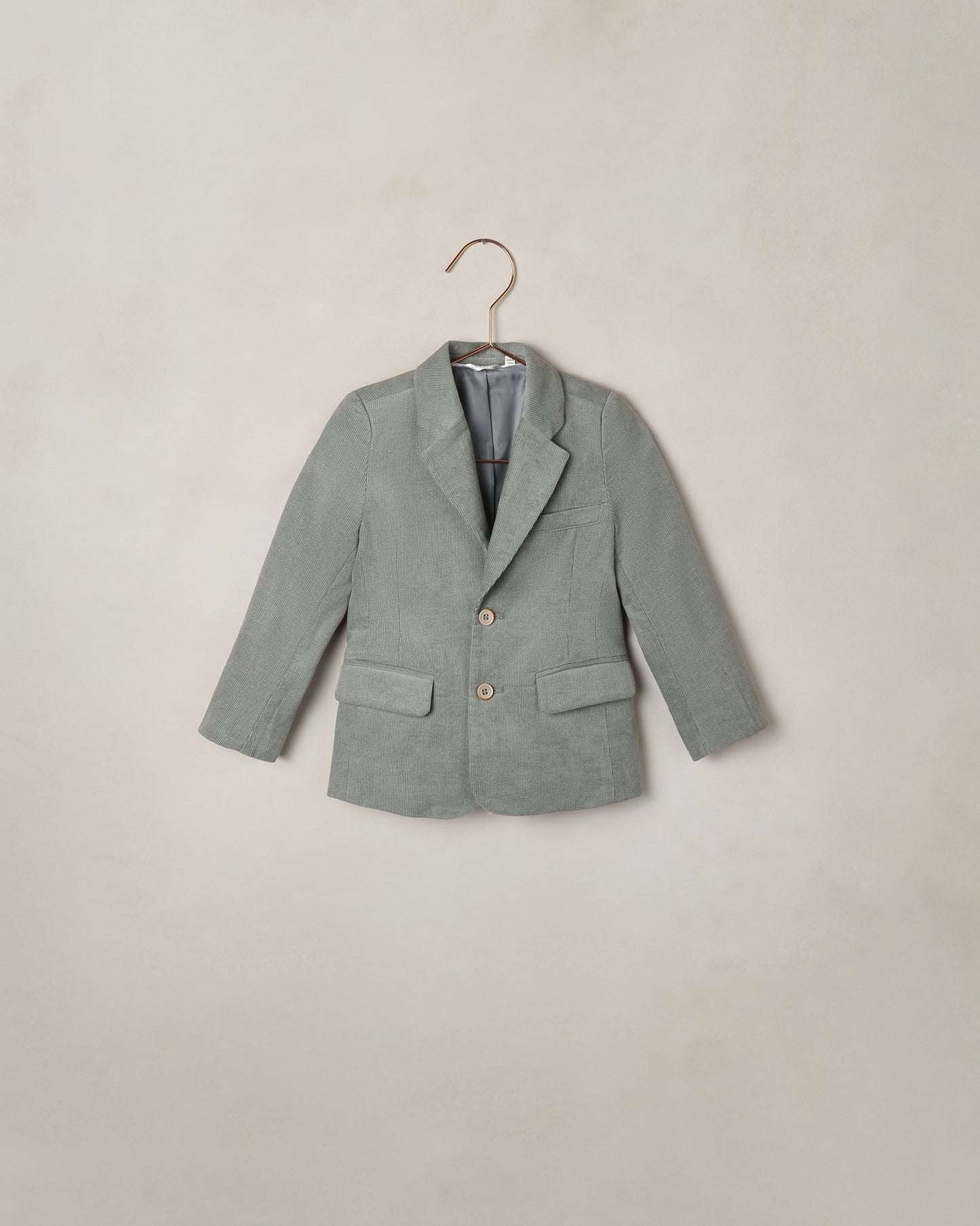 Noralee Eucalyptus Sebastian Blazer shown on a model, featuring tailored design with lapels, front buttons, and long sleeves.