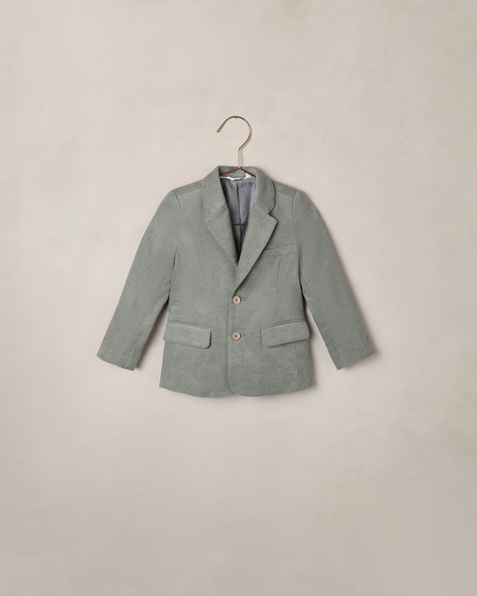 Noralee Eucalyptus Sebastian Blazer shown on a model, featuring tailored design with lapels, front buttons, and long sleeves.