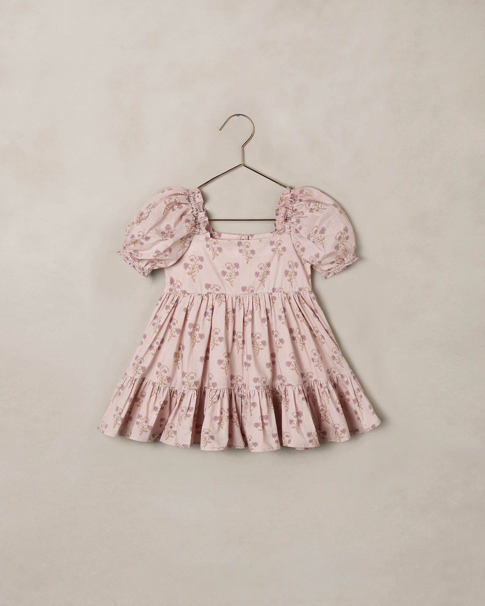 Noralee Florentine Louella Dress shown on a mannequin with floral patterns and flowing fabric, perfect for summer occasions.
