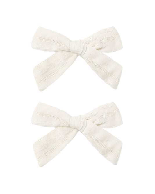 Set of two ivory bows from Rylee & Cru, featuring soft fabric and adorable, versatile hair accessories for children.