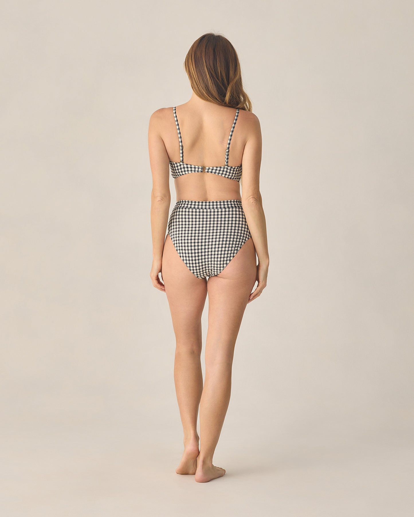 Women's black gingham bandeau bikini top with knotted front from Rylee & Cru, featuring a stylish and flattering swimwear design.