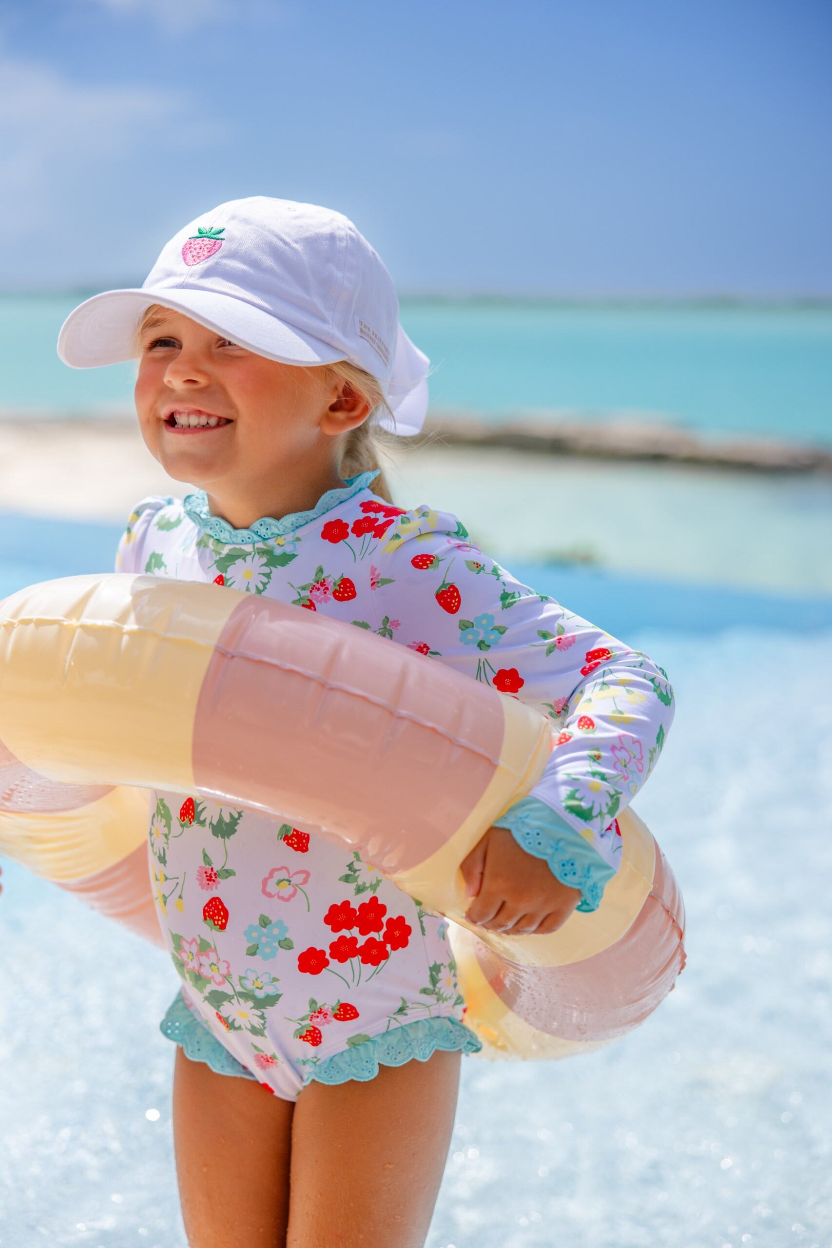 White and strawberry Covington cap by The Beaufort Bonnet Company featuring a classic design and soft fabric.